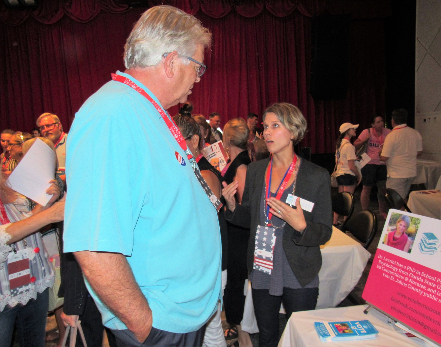 District 4 School Board hopeful Dr. Abigail Levrini shares her platform with a voter at the Politics in St. Johns event July 16 at the Ponte Vedra Concert Hall.